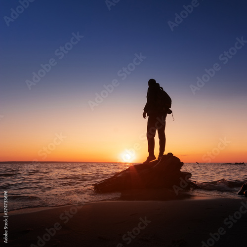 a man looks at the sunset / peaceful landscape Ukraine early spring