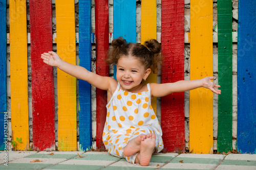 Canvas-taulu Joyful little girl with open hands laughs and sends love to everyone