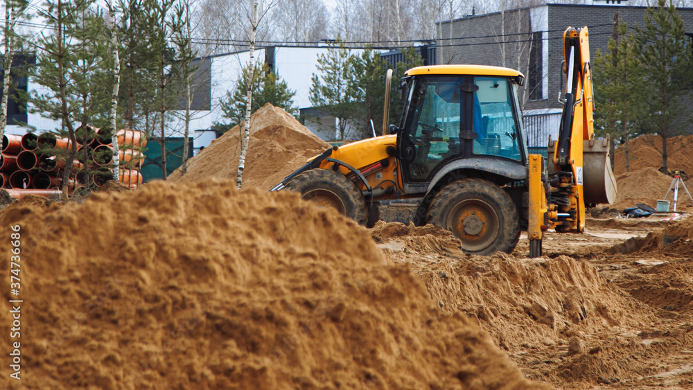 excavator and bulldozer at work on a construction quarter