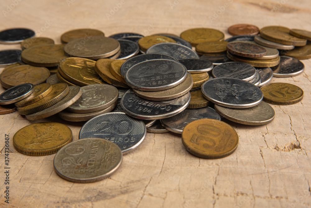 Old coins placed on a rustic wooden platform, selective focus Old coins placed on a rustic wooden platform, selective focus