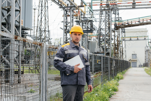 The energy engineer inspects the equipment of the substation. Power engineering. Industry