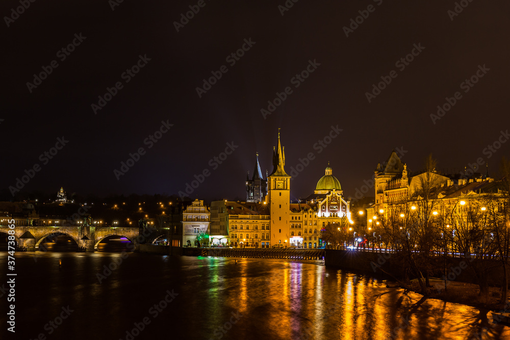 Beautiful night view of the light illuminated Charles Bridge over Vltava River and the Bedrich Smetana Museum in the center of old town of Prague, Czech Republic