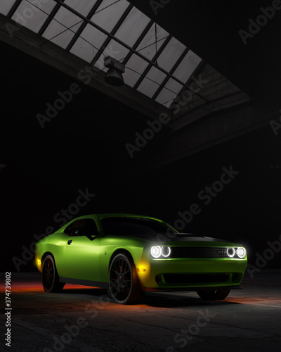 Green Dodge Challenger Hellcat car in a warehouse