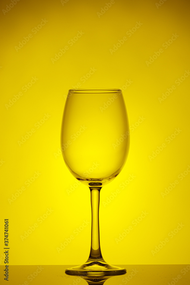 beautiful glass of wine on a yellow background beautiful glass of wine on a yellow background
