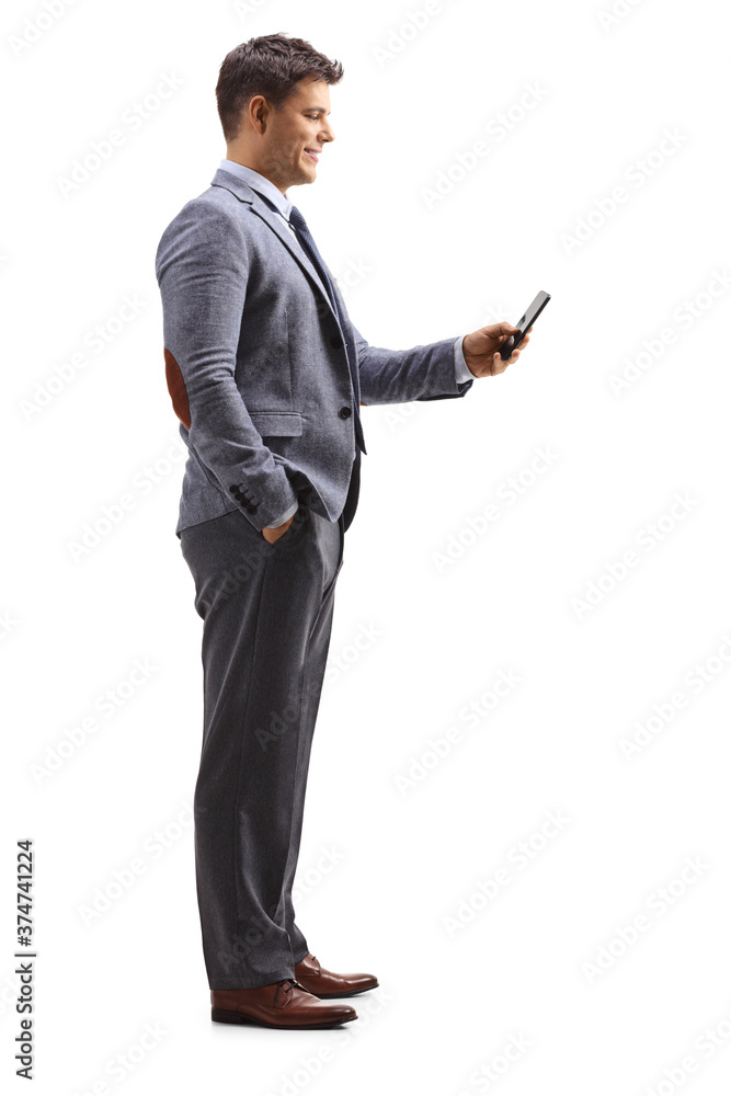 Φωτογραφία Full length profile shot of a professional young man standing and holding a mobi