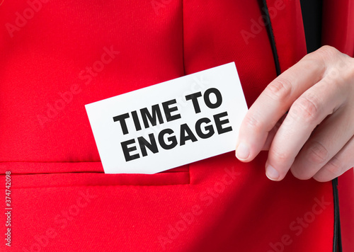 Businessman holding a card with text TIME TO ENGAGE