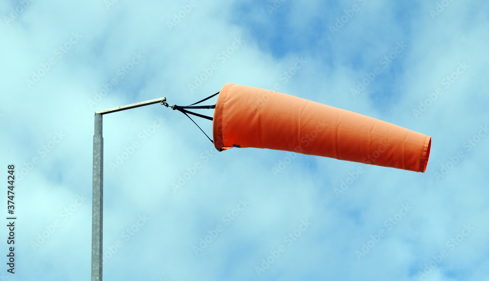 Fotografie Orange Fabric Wind Sock on Metal Pole