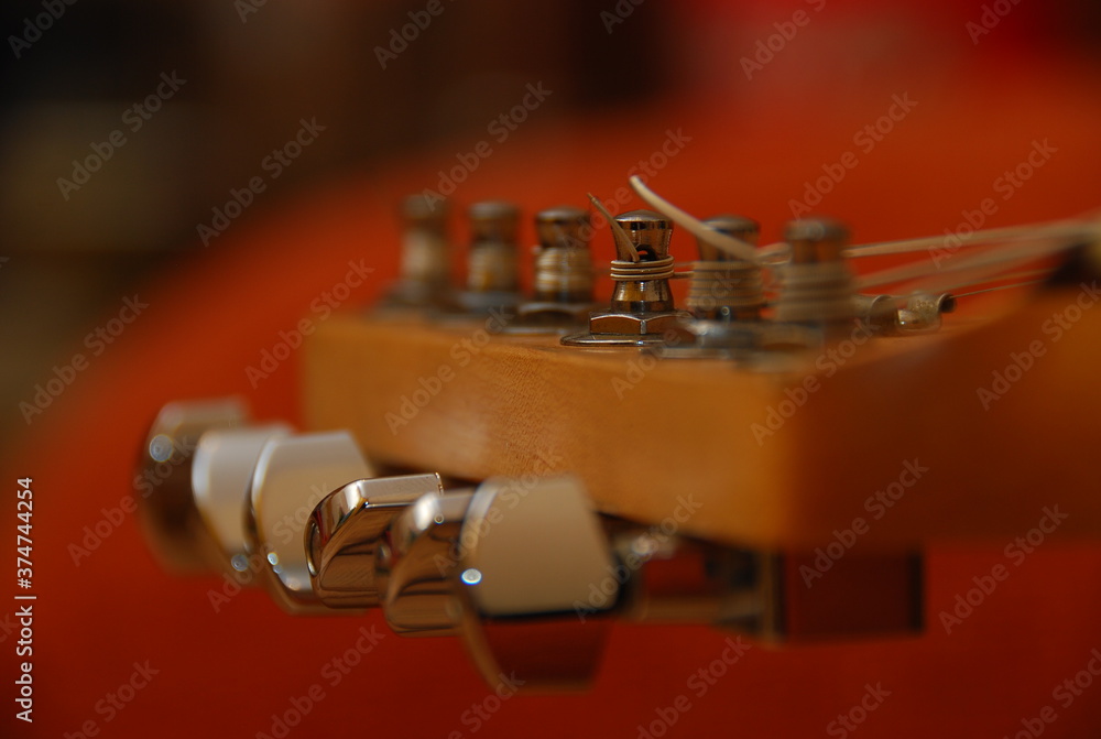 close up of the tuning pegs of an acoustic guitar