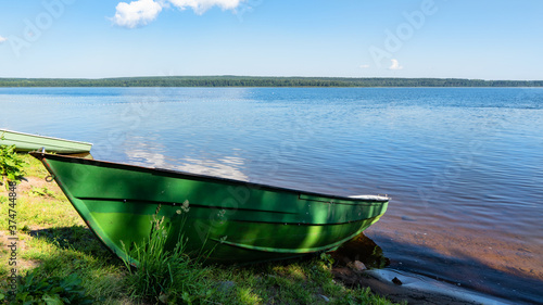 alone boat on the shore of lake Sukhodolskoye in the village of Losevo