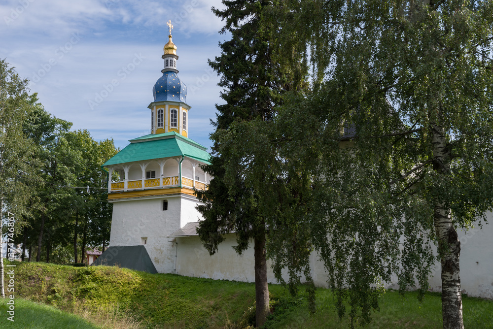 Petrovskaya Tower with fortress wall of Holy Dormition Pskovo-Pechersky Monastery. Pechory, Russia