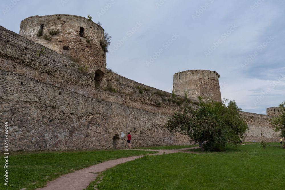 Ryabinovka Tower and Vyshka Tower with wall in medieval Izborsk fortress. Izborsk, Pskov region, Russia.