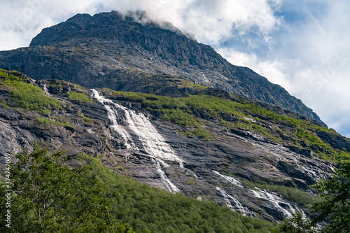 Beautiful mountain landscapes on the road approaching Trollveggen (Troll Wall) part of the mountain massif Trolltindene (Troll Peaks) in the Romsdalen valley, Norway.