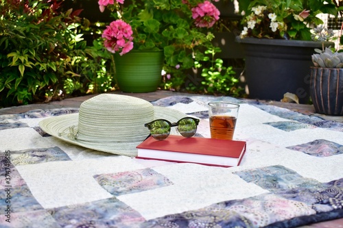 Relaxing outdoor afternoon with book and tea for enjoying a warm summer day during staycation vacation photo