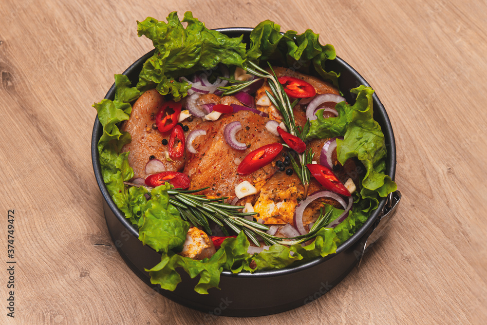 Raw meat. Marbled beef steak in metal baking dish. Vegetables on table. Organic food. Flat lay. Dark Wooden background Raw meat. Marbled beef steak in metal baking dish. Vegetables on table. Organic food. Flat lay. Dark Wooden background