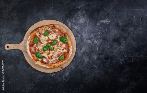Sliced pizza on dark background