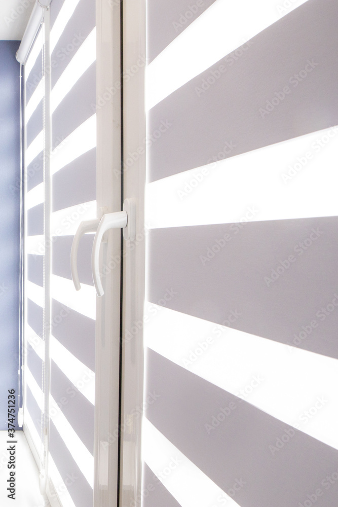 Obraz premium closed window or door with metal jalousie. Office meeting room lighting range control.