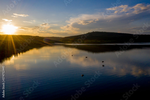 Wallpaper Mural aerial view of fisherman at the boat on golden sunset river. silhouette of fishermen with his boat, Fisherman life style Torontodigital.ca