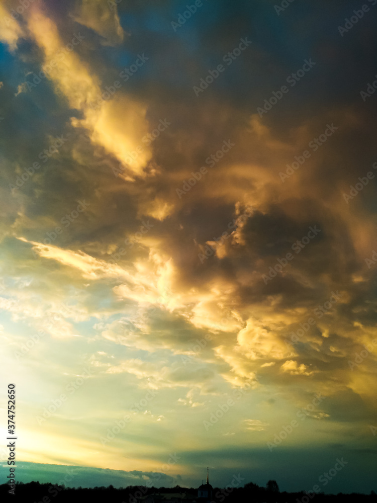 Bright colorful sunset with highlighted clouds