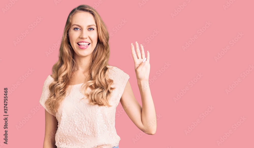 Young beautiful caucasian woman with blond hair wearing casual clothes showing and pointing up with fingers number four while smiling confident and happy. Young beautiful caucasian woman with blond hair wearing casual clothes showing and pointing up with fingers number four while smiling confident and happy.