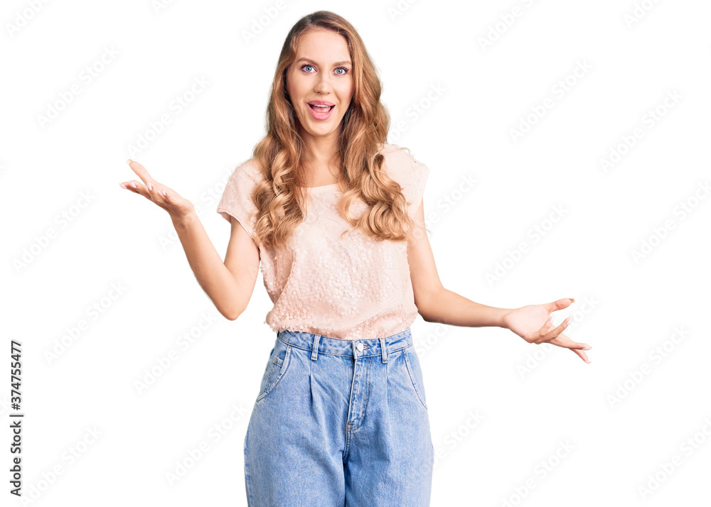 Young beautiful caucasian woman with blond hair wearing casual clothes smiling cheerful with open arms as friendly welcome, positive and confident greetings Young beautiful caucasian woman with blond hair wearing casual clothes smiling cheerful with open arms as friendly welcome, positive and confident greetings