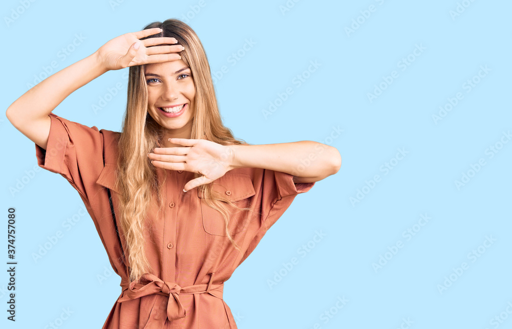 Beautiful caucasian woman with blonde hair wearing summer jumpsuit smiling cheerful playing peek a boo with hands showing face. surprised and exited Beautiful caucasian woman with blonde hair wearing summer jumpsuit smiling cheerful playing peek a boo with hands showing face. surprised and exited