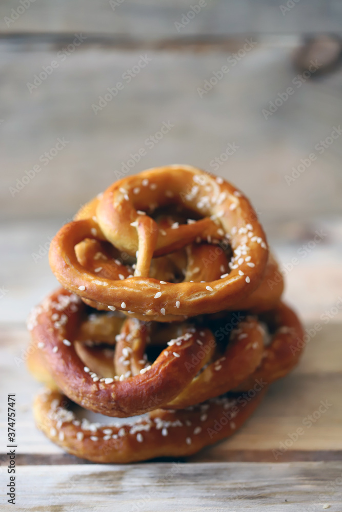 Fresh homemade pretzels on a wooden surface. Oktoberfest symbol. Fresh homemade pretzels on a wooden surface. Oktoberfest symbol.
