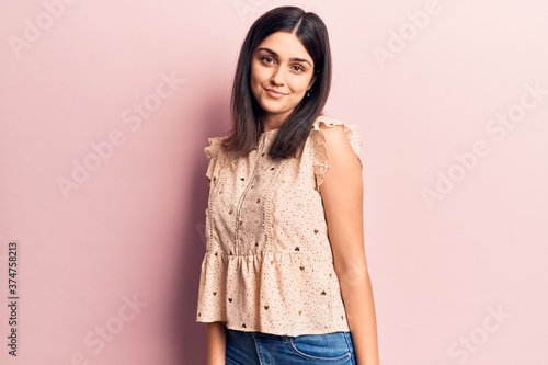Young beautiful girl wearing casual clothes smiling happy and confident. Standing with smile on face over isolated pink background