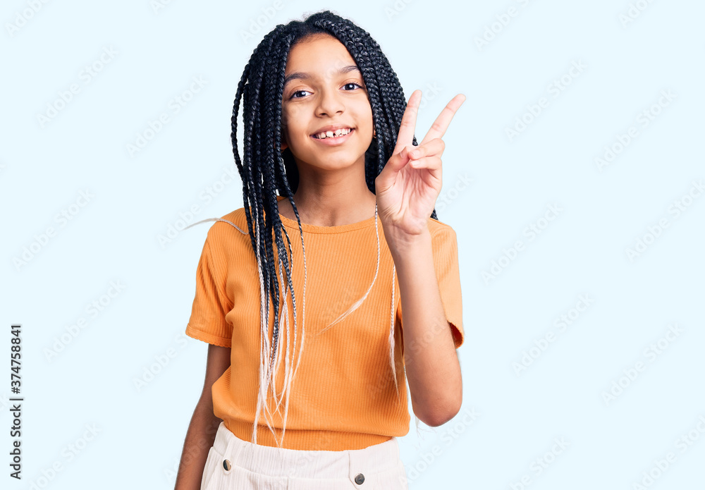 Cute african american girl wearing casual clothes showing and pointing up with fingers number two while smiling confident and happy. Cute african american girl wearing casual clothes showing and pointing up with fingers number two while smiling confident and happy.