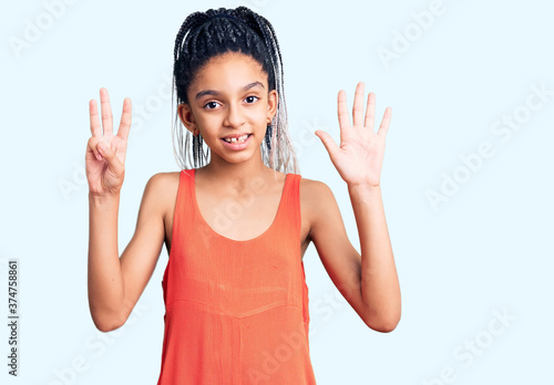 Cute african american girl wearing casual clothes showing and pointing up with fingers number eight while smiling confident and happy.