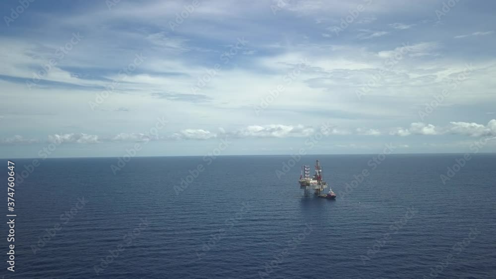 Aerial view from a drone of an offshore jack up rig and offshore supply vessels at the offshore location during day time
Aerial view from a drone of an offshore jack up rig and offshore supply vessels at the offshore location during day time
