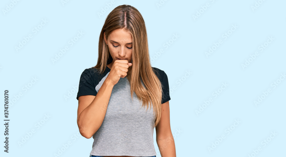 Young blonde woman wearing casual clothes feeling unwell and coughing as symptom for cold or bronchitis. health care concept.