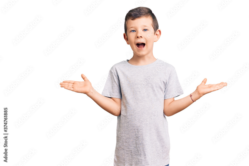 Cute blond kid wearing casual clothes celebrating victory with happy smile and winner expression with raised hands Cute blond kid wearing casual clothes celebrating victory with happy smile and winner expression with raised hands