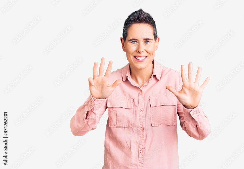 Young woman with short hair wearing casual clothes showing and pointing up with fingers number nine while smiling confident and happy. Young woman with short hair wearing casual clothes showing and pointing up with fingers number nine while smiling confident and happy.