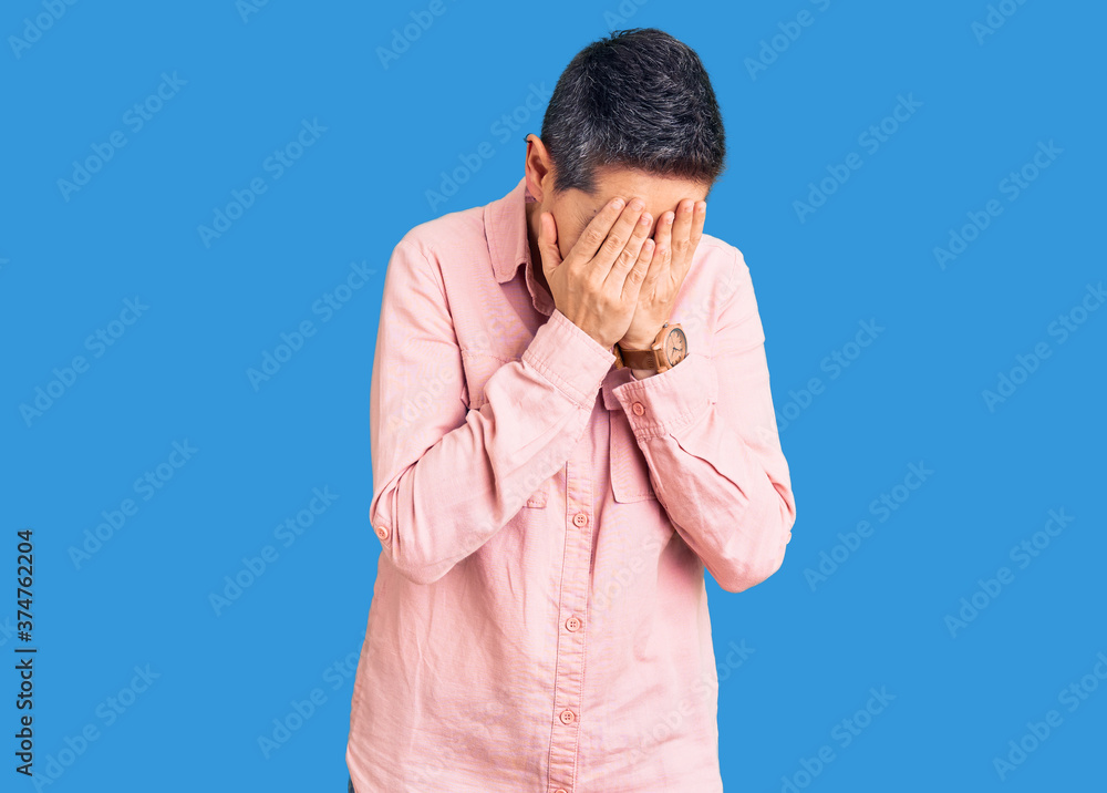 Young woman with short hair wearing casual clothes with sad expression covering face with hands while crying. depression concept. Young woman with short hair wearing casual clothes with sad expression covering face with hands while crying. depression concept.