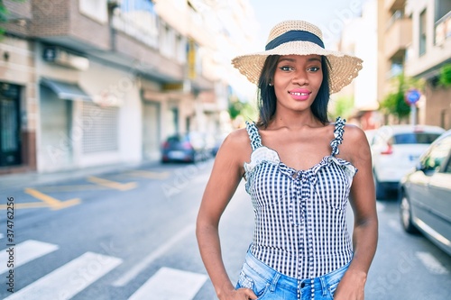 Young african american woman on vacation smiling happy walking at street of city © Krakenimages.com