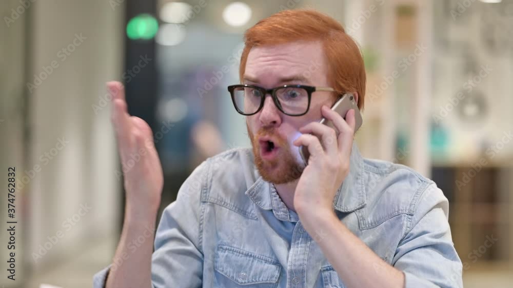 Portrait of Aggressive Casual Redhead Man Angry on Smartphone Portrait of Aggressive Casual Redhead Man Angry on Smartphone
