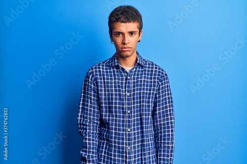 Young african amercian man wearing casual clothes depressed and worry for distress, crying angry and afraid. sad expression.