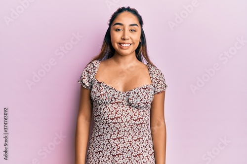 Young latin woman wearing casual clothes with a happy and cool smile on face. lucky person. © Krakenimages.com