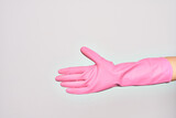 Hand of caucasian young woman wearing pink cleaning glove doing give me sign. Showing opened empty palm over isolated white background