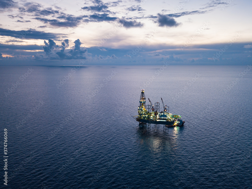 Aerial view from a drone of an offshore jack up rig at the offshore location during twilight time