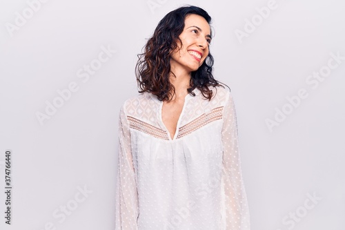 Young beautiful hispanic woman wearing casual clothes looking away to side with smile on face, natural expression. laughing confident. © Krakenimages.com