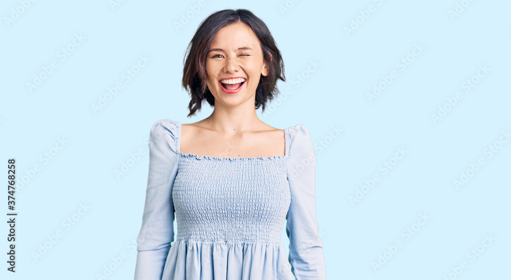 Young beautiful girl wearing casual clothes winking looking at the camera with sexy expression, cheerful and happy face. Young beautiful girl wearing casual clothes winking looking at the camera with sexy expression, cheerful and happy face.