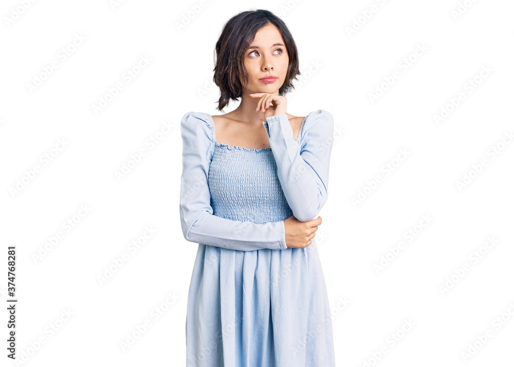 Young beautiful girl wearing casual clothes with hand on chin thinking about question, pensive expression. smiling with thoughtful face. doubt concept. Young beautiful girl wearing casual clothes with hand on chin thinking about question, pensive expression. smiling with thoughtful face. doubt concept.