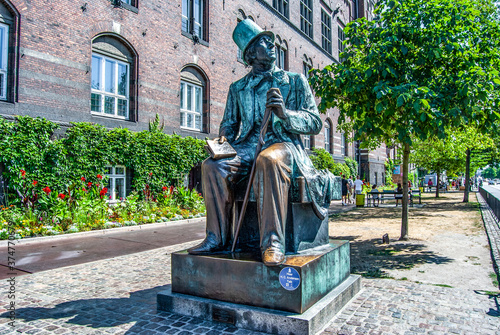 Bronze statue of Danish writer Hans Christian Andersen in Copenhagen City Hall square, facing H.C. Andersens Boulevard and the Tivoli Gardens, Copenhagen, Denmark. photo