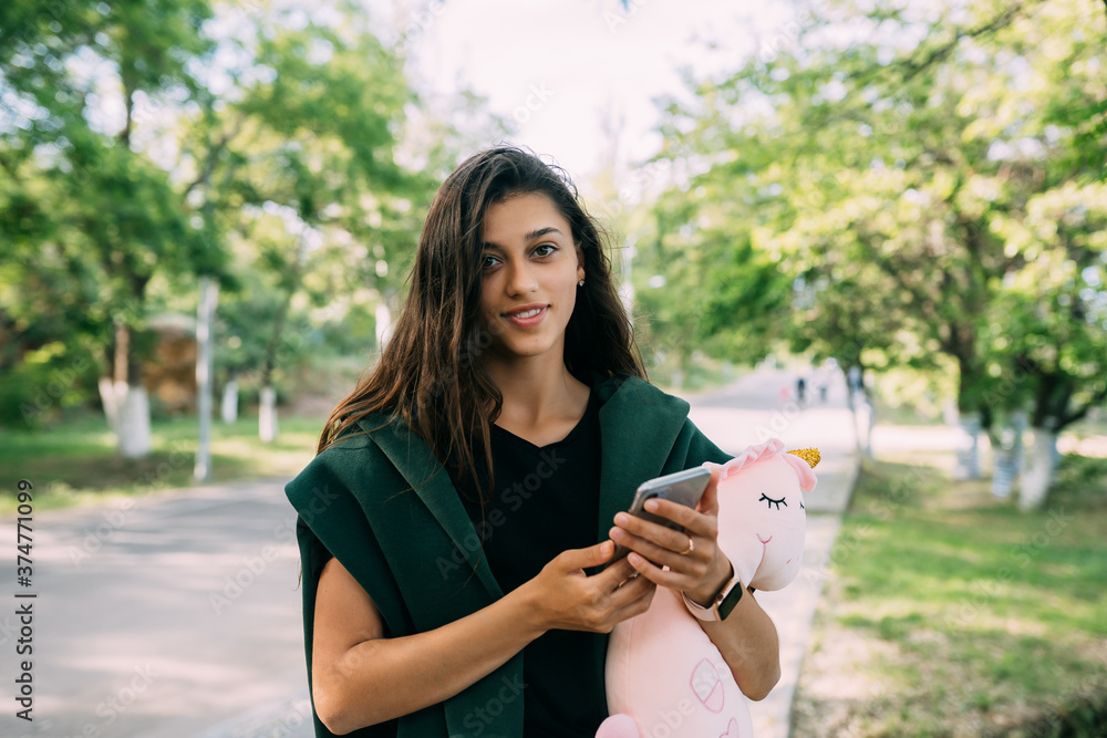 Young Attractive Girl Typing Messages on her Mobile. Young Attractive Girl Typing Messages on her Mobile.