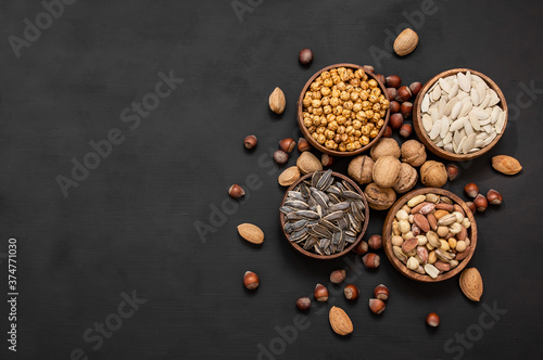 Mixed nuts, dried fruits on wooden table, different kind of healthy food