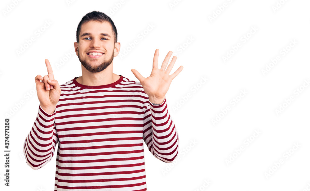 Young handsome man wearing striped sweater showing and pointing up with fingers number six while smiling confident and happy. Young handsome man wearing striped sweater showing and pointing up with fingers number six while smiling confident and happy.