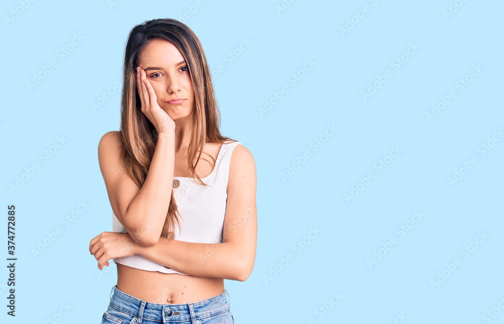 Fototapeta premium Young beautiful girl wearing casual sleeveless t shirt thinking looking tired and bored with depression problems with crossed arms.