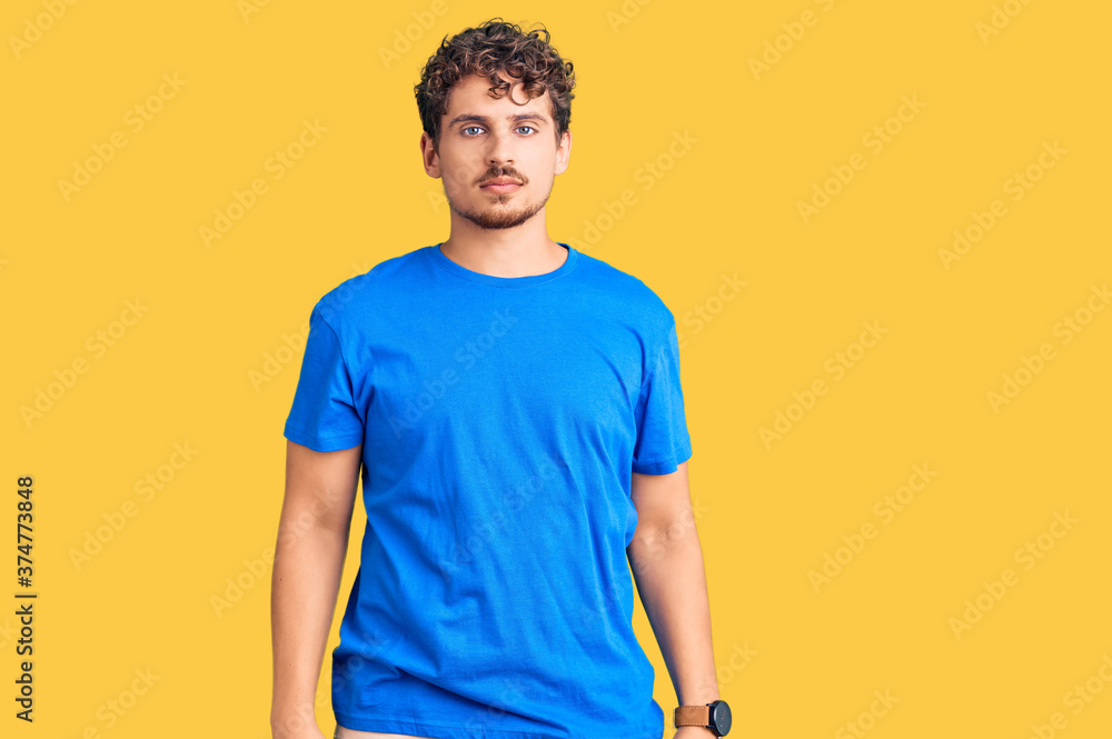 Young handsome man with curly hair wearing casual clothes looking sleepy and tired, exhausted for fatigue and hangover, lazy eyes in the morning. Young handsome man with curly hair wearing casual clothes looking sleepy and tired, exhausted for fatigue and hangover, lazy eyes in the morning.