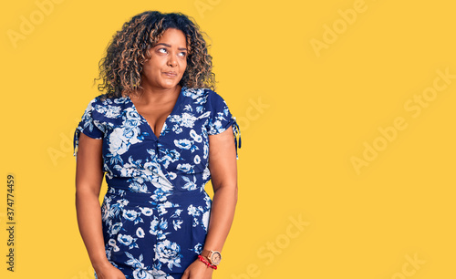 Young african american plus size woman wearing casual clothes smiling looking to the side and staring away thinking. © Krakenimages.com